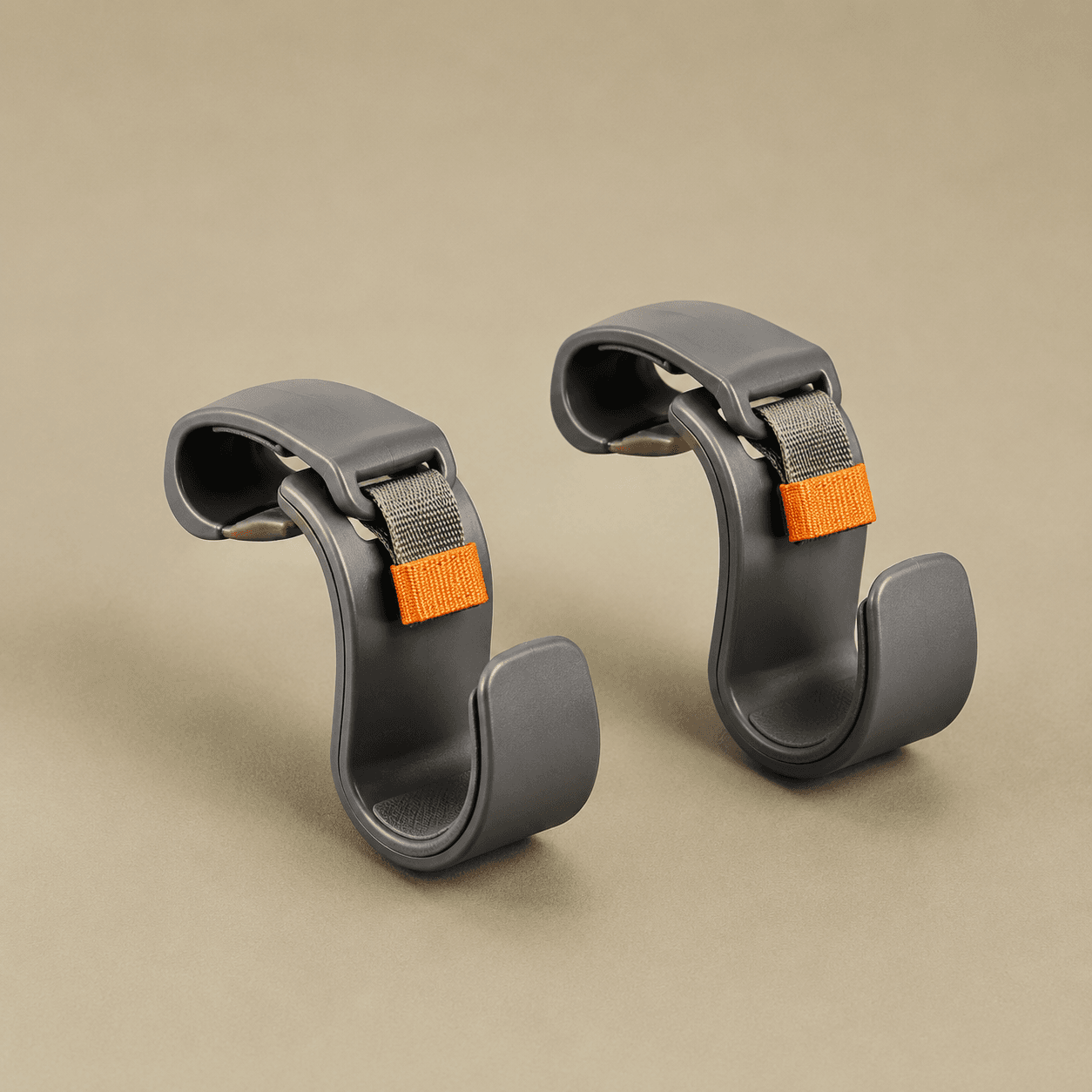 Pair of grey clip-on headrest hooks, studio shot